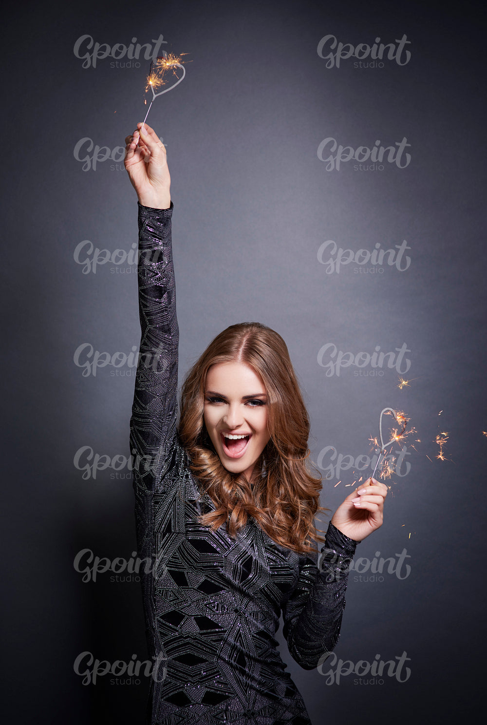 Woman dancing with heart shape sparkler