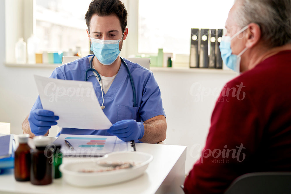 Doctor reviews the results of senior patient