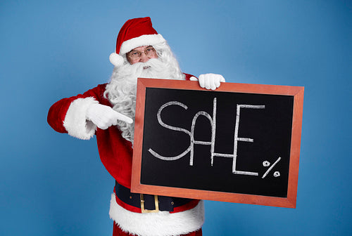 Man in santa claus costume with christmas banner