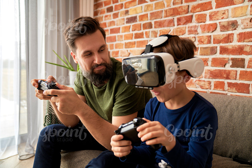 Father and son spending time together and playing video game