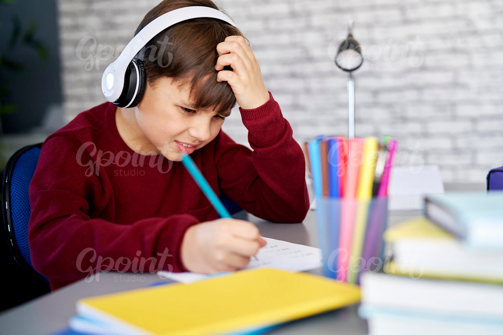 Frustrated schoolboy doing homework at home