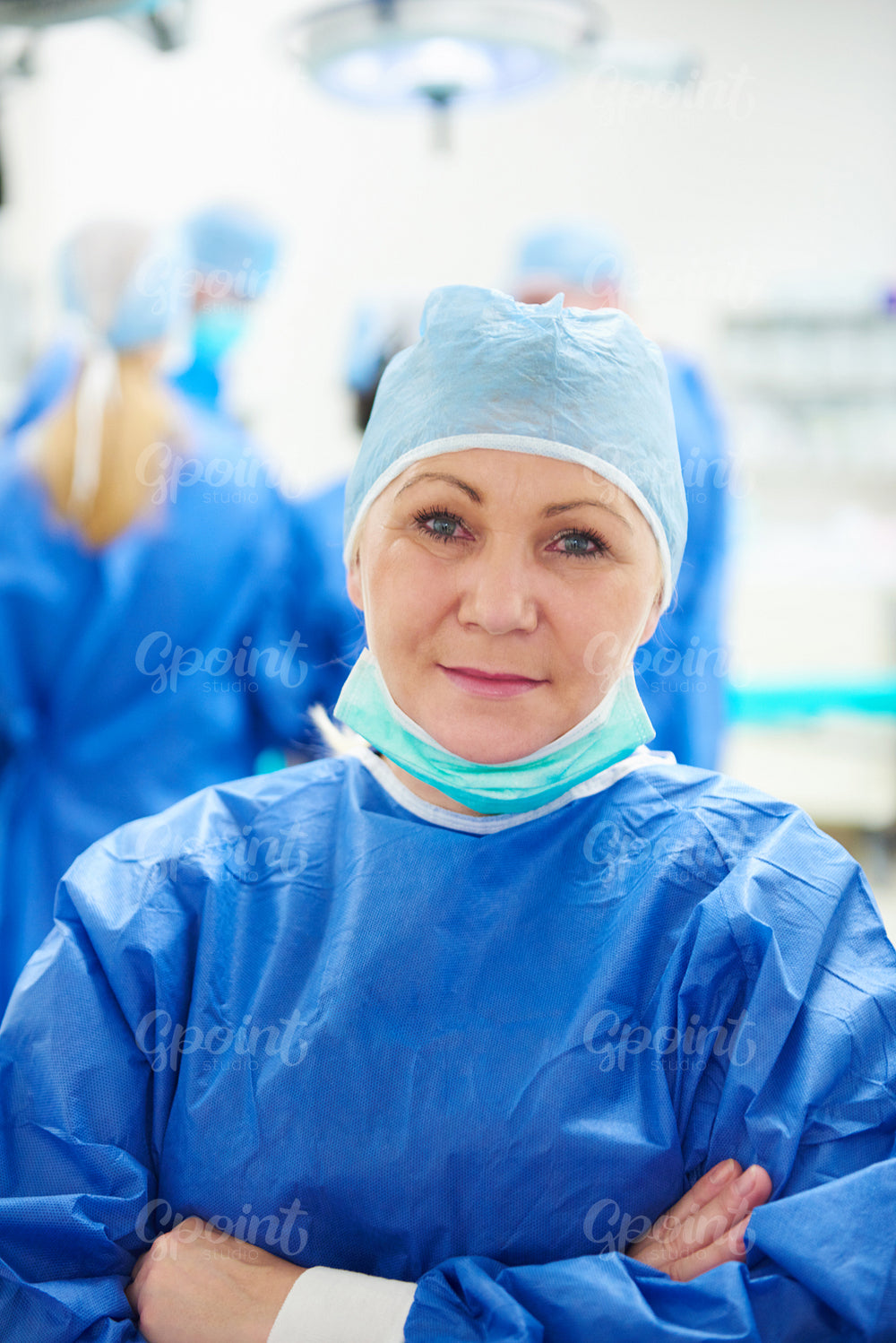 Portrait of mature doctor in surgical uniform