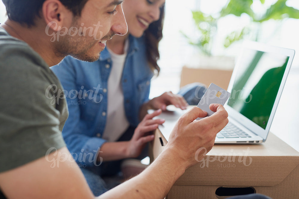 Young couple doing online shopping on laptop
