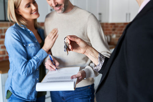Couple signing contract of new apartment