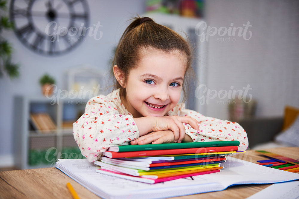Smiling girl studying at home