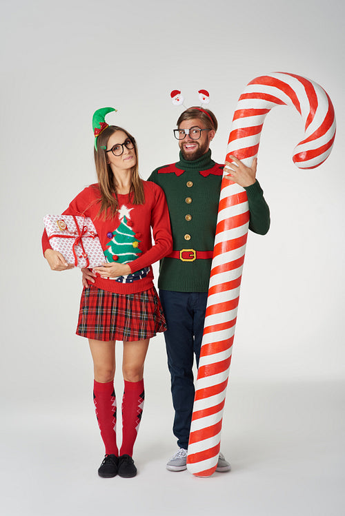 Huge candy cane and Christmas couple