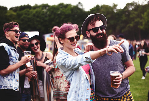 Couple standing in crowd at music festival