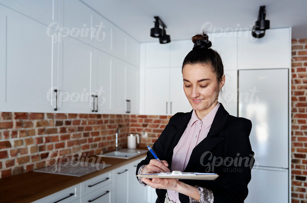 Real estate agent fills out documents in a new apartment