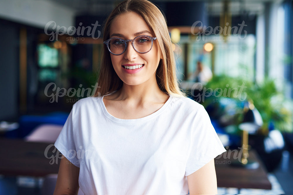 Portrait of smiling, young woman with glasses