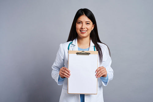 Smiling doctor with empty piece of paper