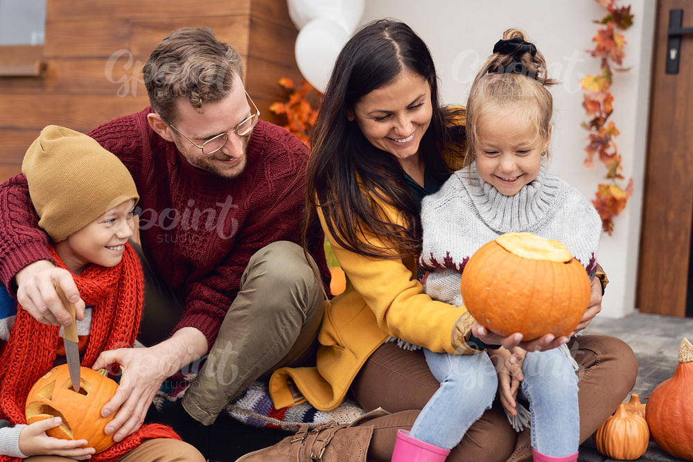 Family with pumpkins in Halloween 