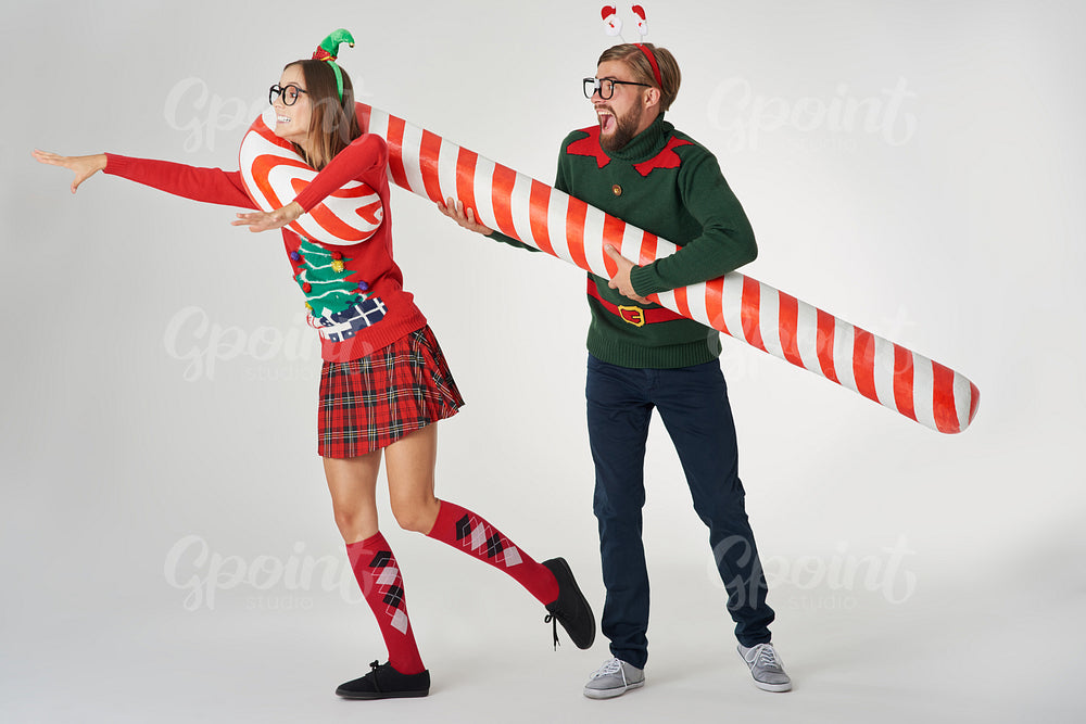 Man catching his girlfriend with a candy cane