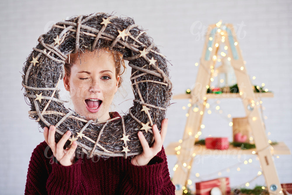 Screaming woman holding christmas wreath