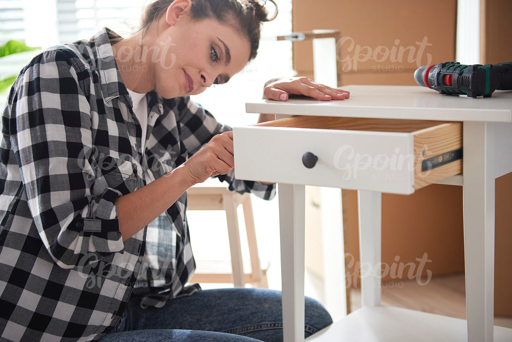 Young woman renovating a night table
