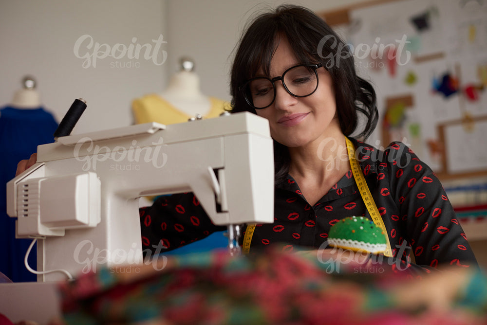 Attractive brunette and sewing machine