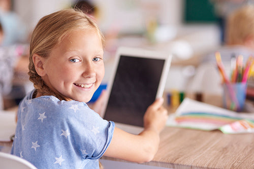 Girl using digital tablet at school