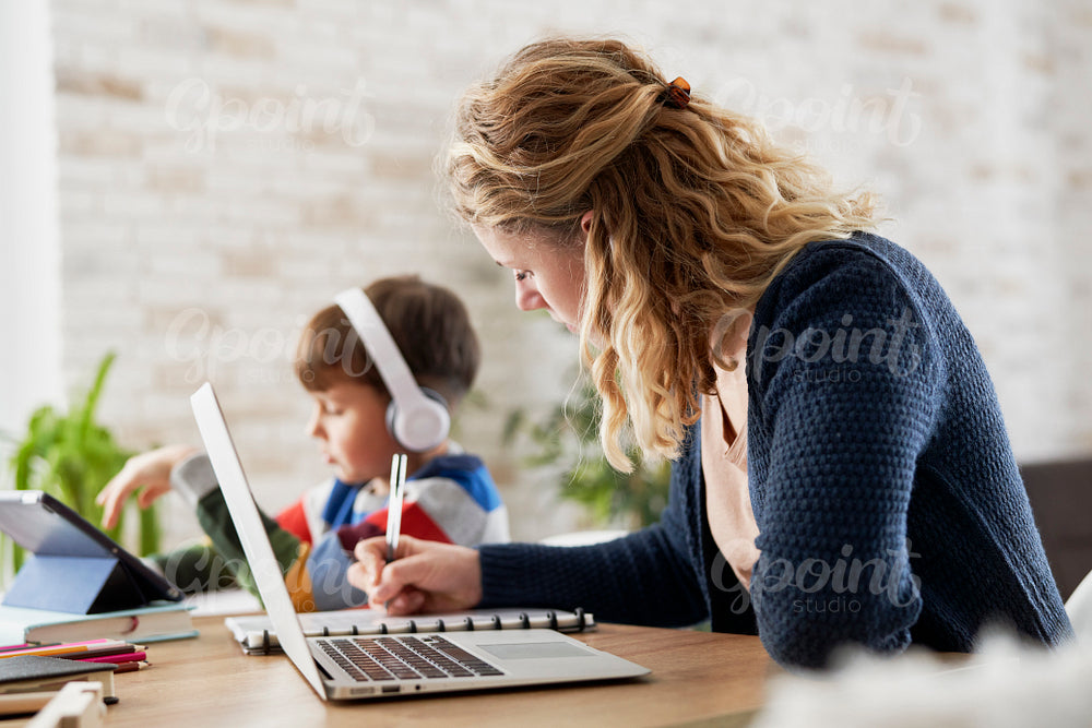 Mother during home office and son during homeschooling