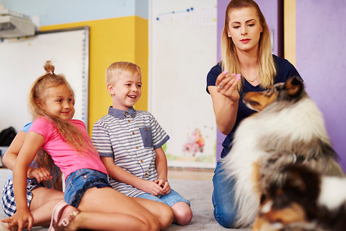 Happy kids with dog during therapy