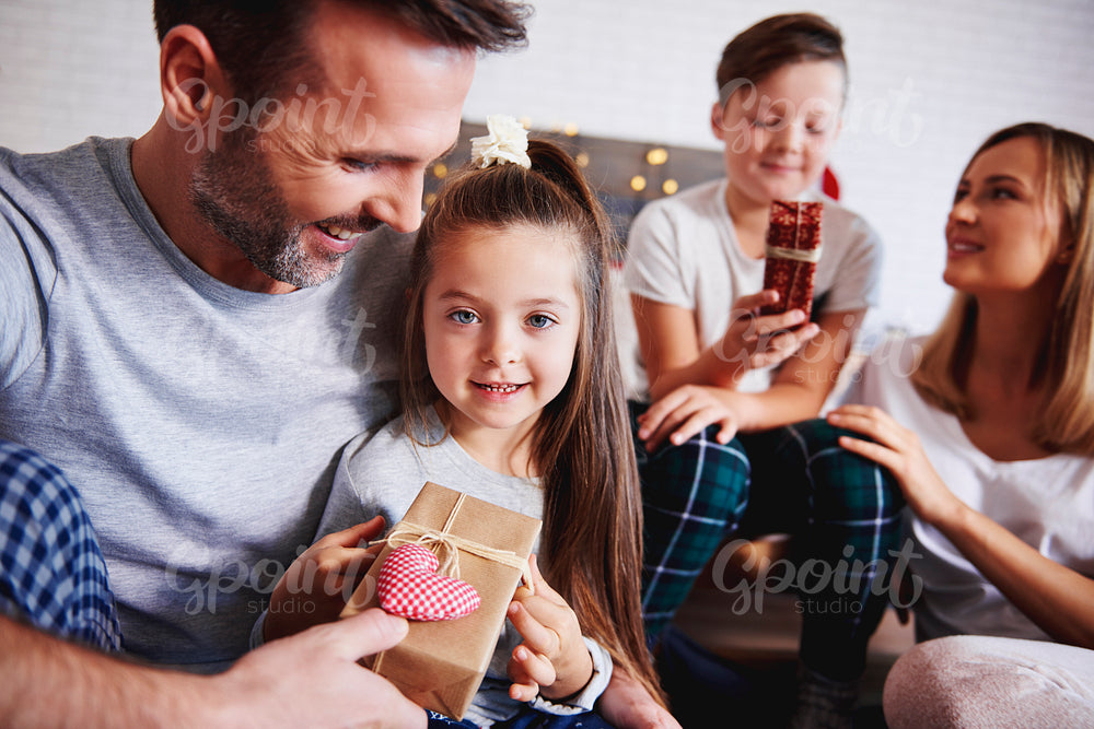 Affectionate father giving christmas present to his daughter