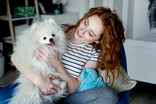 Redhead woman playing with her dog