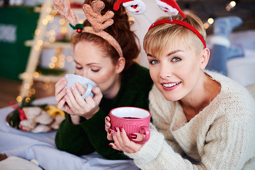 Two girls drinking hot tea or mulled wine