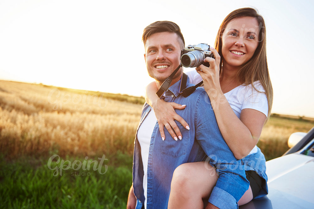 Loving couple with camera in outdoor.