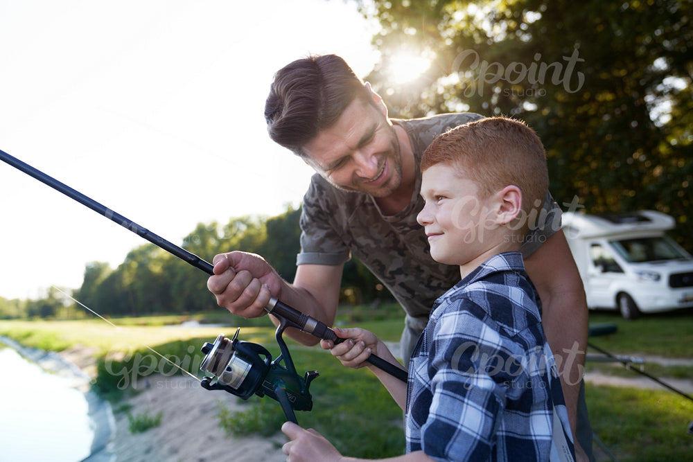 Father and son spending time on fishing together