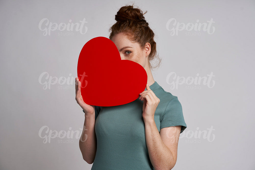 Flirting woman behind the heart 