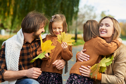 Cheerful scene of family in autumn forest