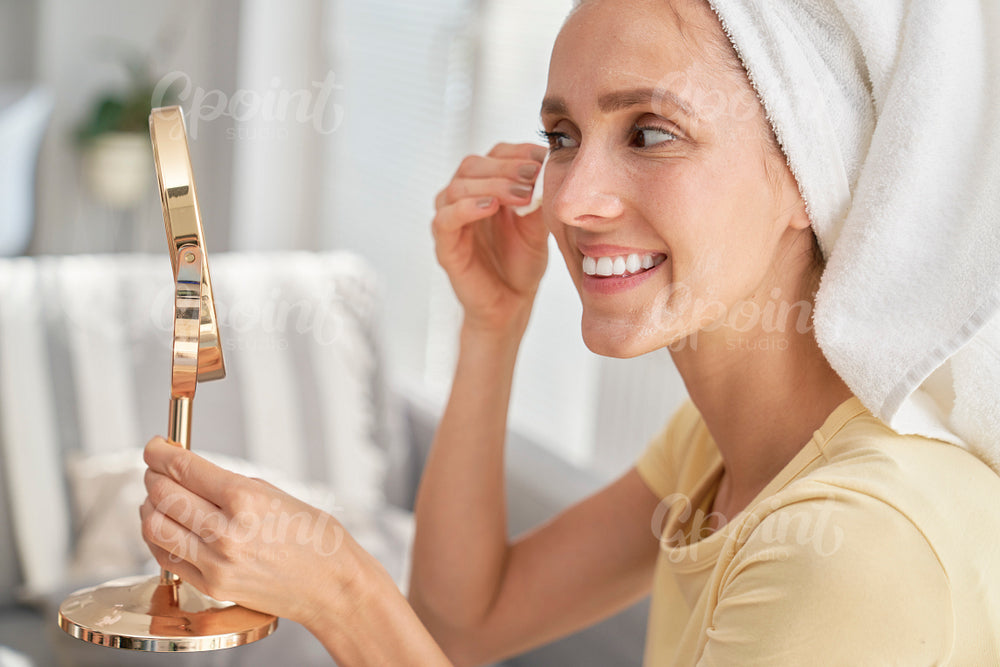Woman removing make up at home