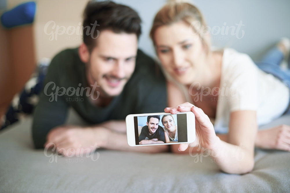 Playful couple having fun by taking pictures