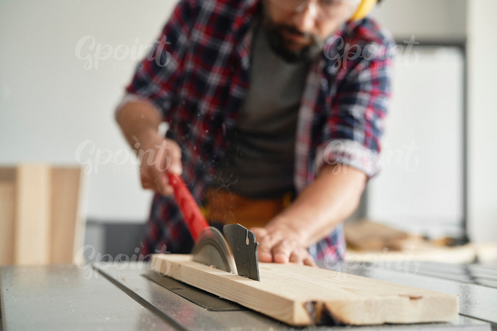 Close up carpenter using a circular saw