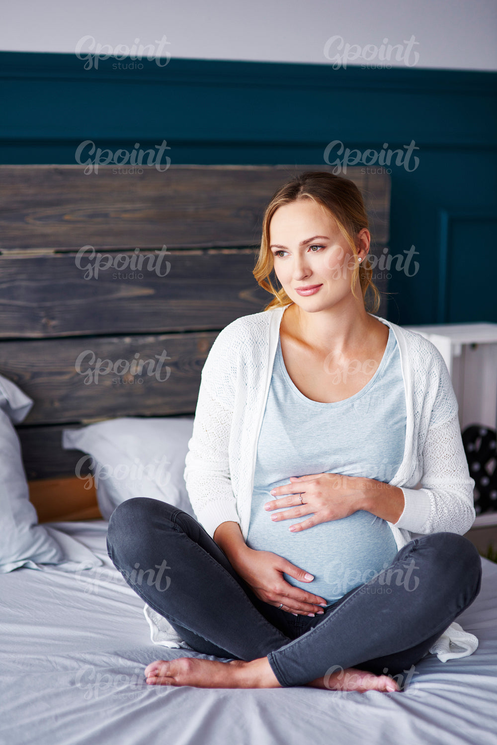 Portrait of pregnant woman at bedroom