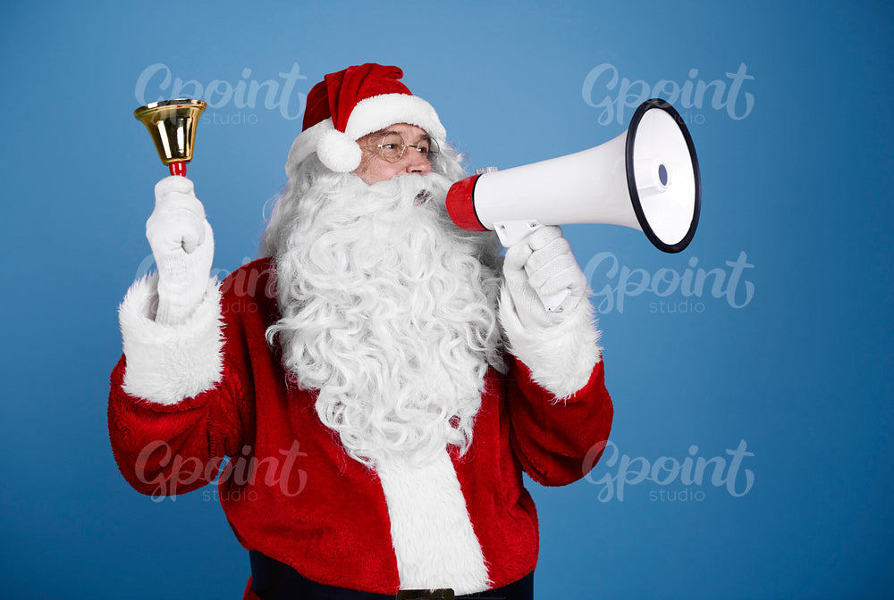 Santa claus with handbell shouting into megaphone