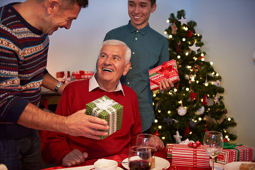 Very happy grandfather receiving Christmas presents