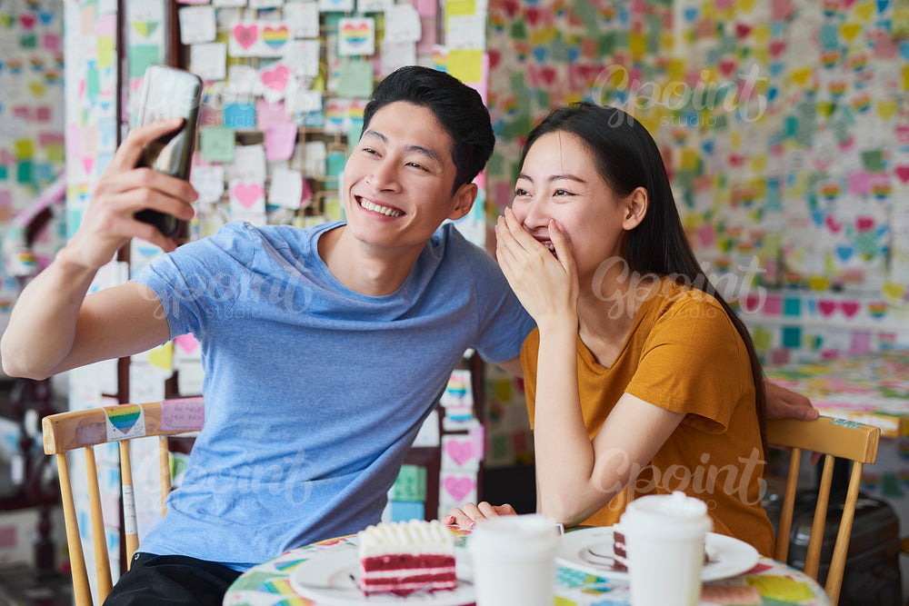 Loving couple making a selfie in a cafe