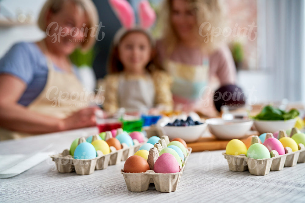 Close up of family coloring Easter eggs at home