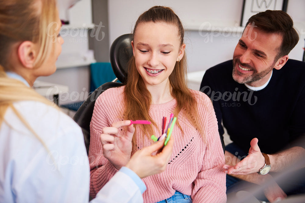 Girl choosing the color of rubber bands for braces