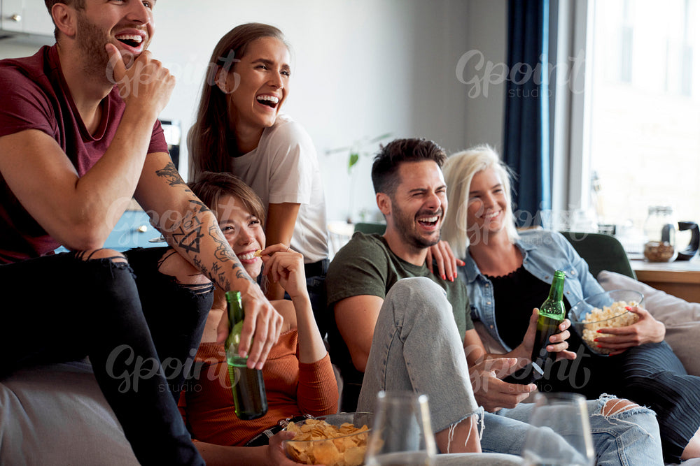 Friends watching a comedy on TV
