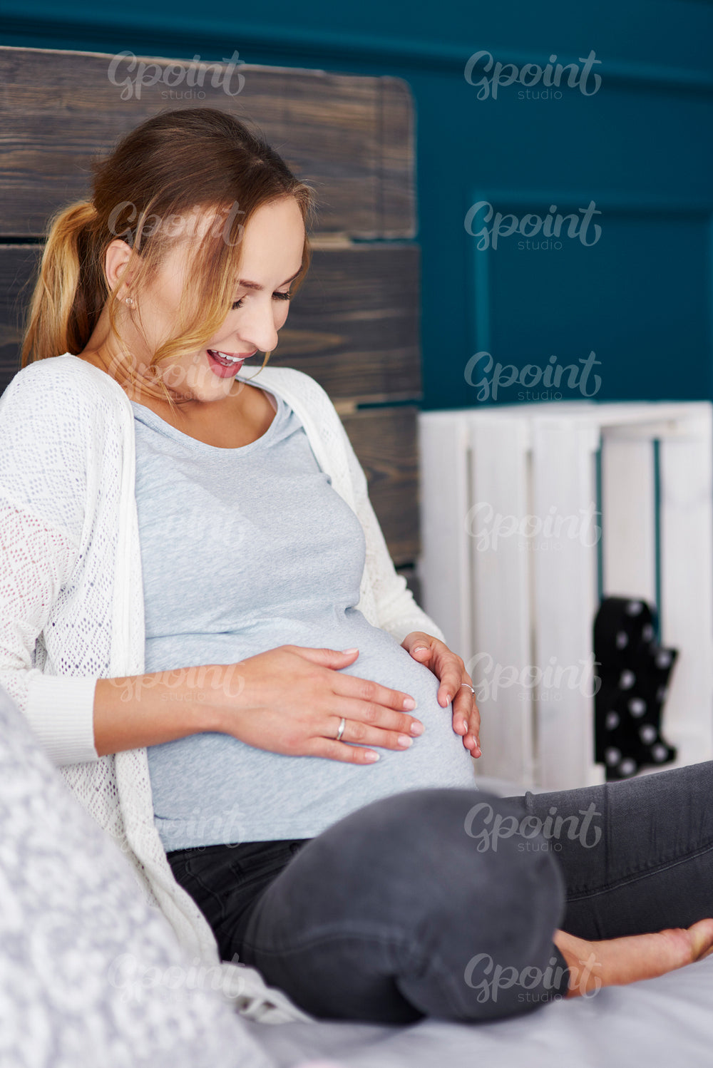 Surprised pregnant woman touching her belly