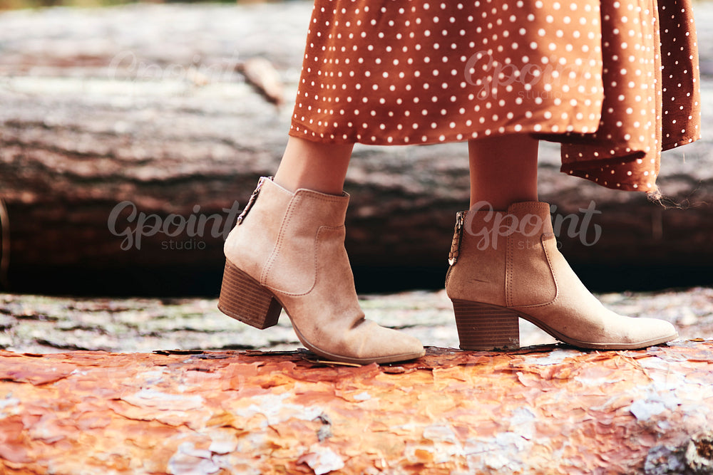Boots of woman in autumnal forest