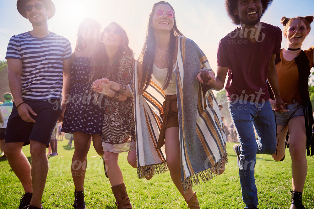 Group of happy people running at the music festival
