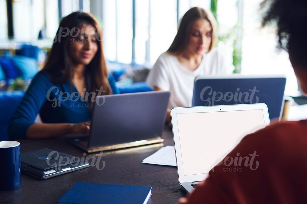 Blurred view of coworkers working at office desk