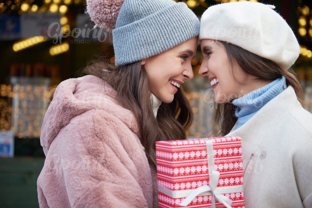 Two women in love  holding one Christmas gift