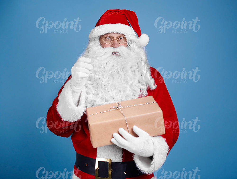 Surprised santa claus opening gift