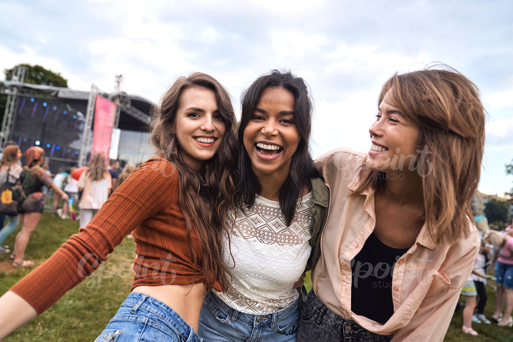 Group of multiracial friends have fun at music festival   