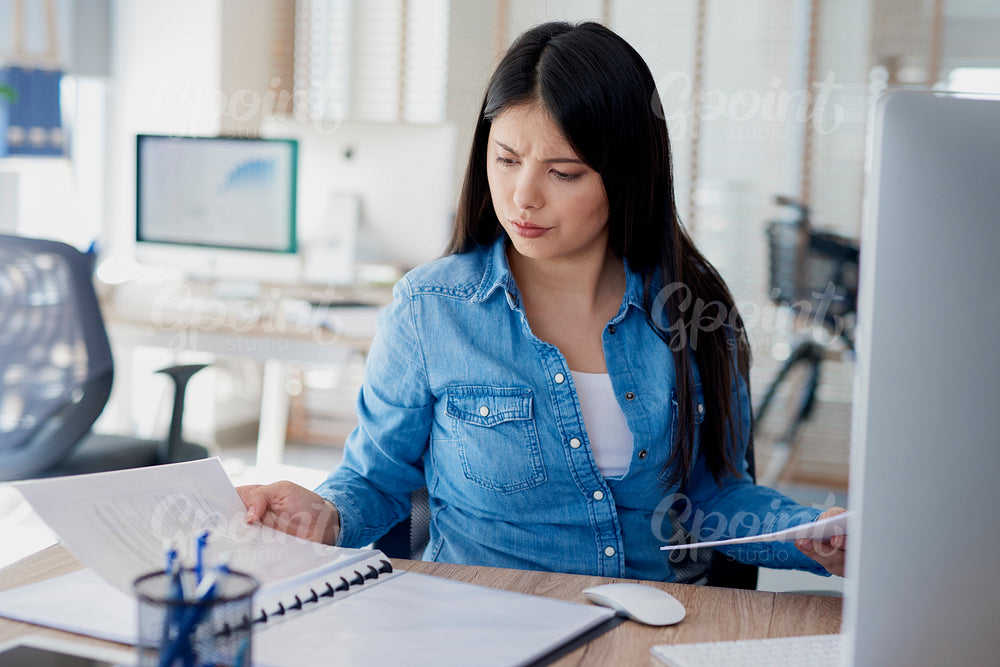 Woman analyzing some documents with a serious face expression