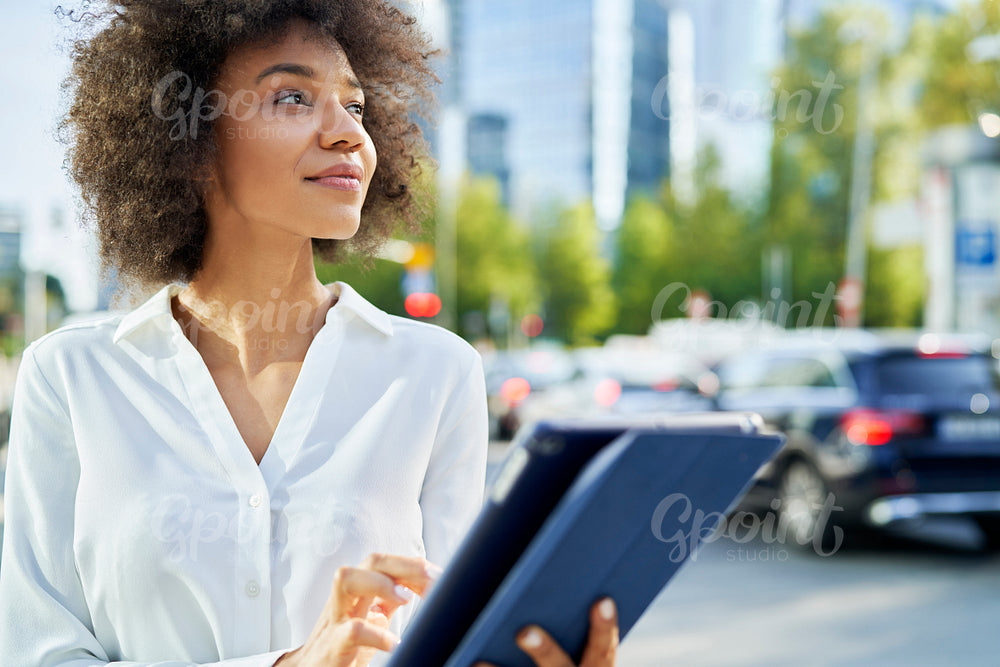 Businesswoman with digital tablet in the city