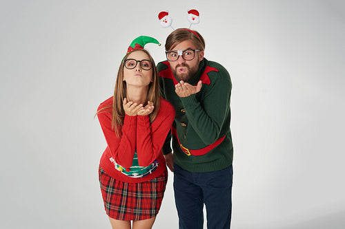 Couple blowing some Christmas kisses