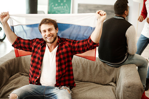 Happy football fans waving a russian flag